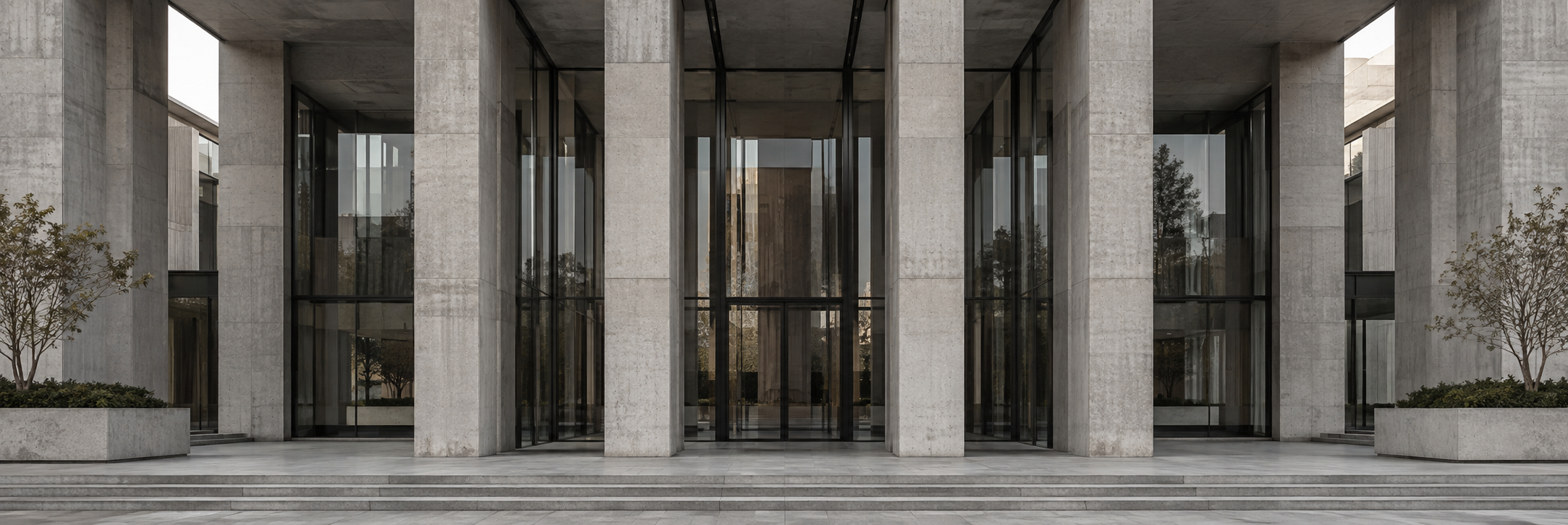 Glass façade of a corporate office building against a clear sky